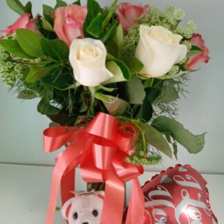 Cream and pinks roses in glass vase with teddy and balloon